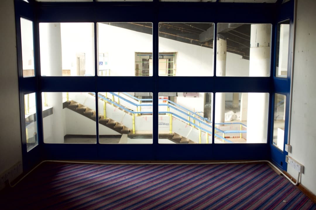 Photo from a glass-covered balcony looking into a foyer