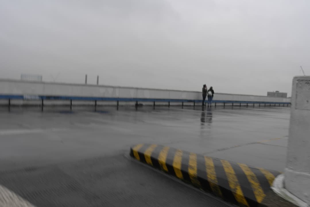 Photo of a couple looking at a view on a rainy day
